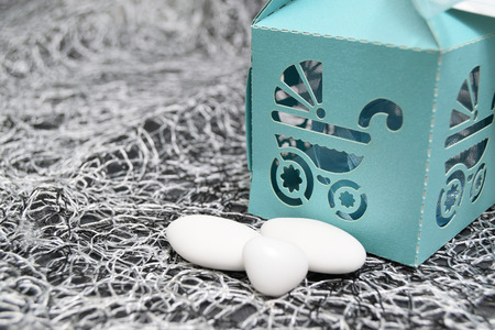 box with pram-shaped cutout and almond confetti insideの写真素材