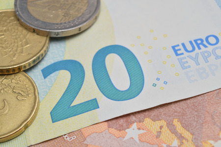 close up of various coins and euro banknotes