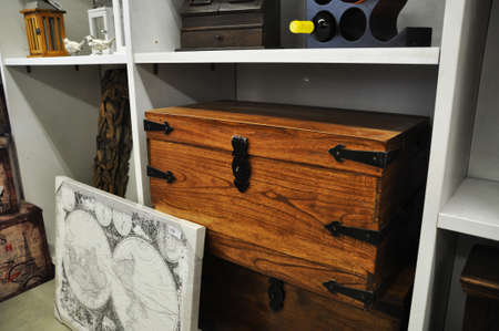 Large brown chest, with metal corners under a shelf in white