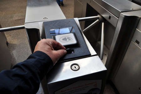 Payment for metro travel. In hand a token for payment of travel
