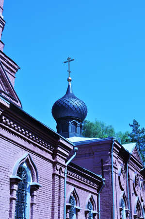 Blue dome with a cross. The building of the Christian church against the blue sky. The old church.