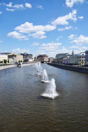 Panoramic view of the river with fountains along the fairway. River, fountains, embankment and old houses.のeditorial素材