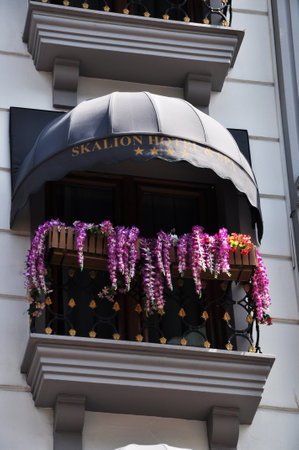 Semicircular balcony with a circular awning. Purple flowers on the balcony. 09 July 2021, Istanbul, Turkey.のeditorial素材