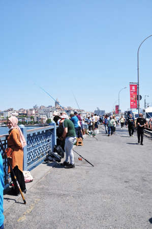 Panoramic view of Istanbul. Fishermen on the Galata Bridge catch fish. 09 July 2021, Istanbul,...