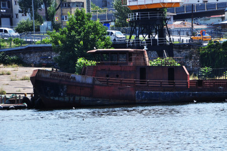 An old, rusty ship near the shore. The ship is off the coast. View of the Bosphorus with an old ship. 09 July 2021, Istanbul, Turkey.のeditorial素材
