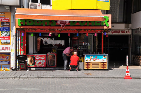 View of a street cafe in Istanbul. Men prepare street food. 09 July 2021, Istanbul, Turkey.のeditorial素材