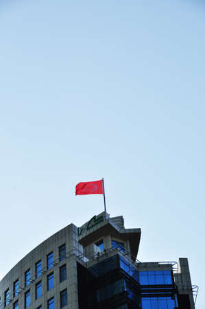 House with the flag of the Turkish Republic. Flag on the building against the blue sky. 09 July 2021, Istanbul, Turkey.のeditorial素材