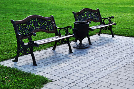 Two beautiful benches in the city square. Cast iron bench backs. A place to rest.の写真素材