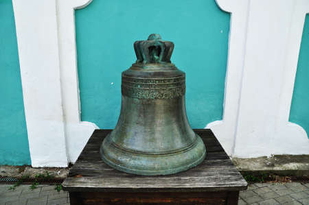 Bell, close-up. The church bell from the bell tower stands on a wooden base.の写真素材