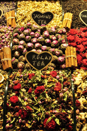 Sale of different types of tea. Fruit tea on the market counter. Cinnamon sticks are tied with...