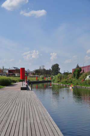 Panoramic view of the embankment and the river. A flock of ducks on the river. People walk along the embankment. August 16, 2021, Tula, Russia.のeditorial素材