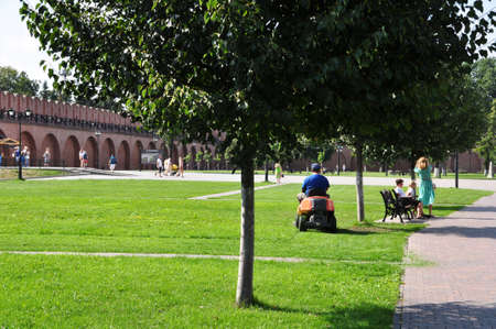 In the courtyard of the Kremlin, a worker mows the grass. Sightseeing. August 16, Tula, Russiaのeditorial素材