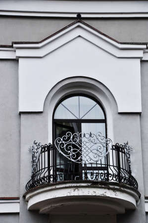 Architectural detail of the building. View of a beautiful balcony with a figured parapet made of metal strips.の写真素材