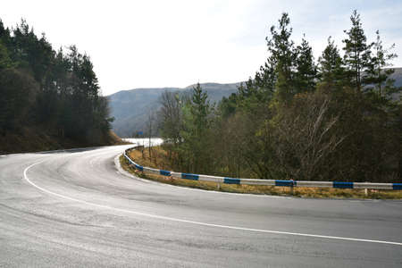 Panoramic view of the road in the mountains. Sharp turns of a mountain road.の写真素材