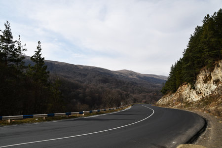 Mountain road landscape. Steep descent along a mountain road. Nice view of the mountains.の写真素材