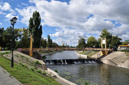 Panoramic view of the Orlik river and the bridge. View of a small waterfall on the river. September...