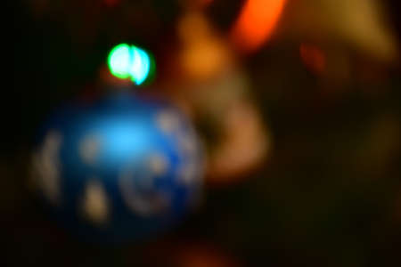 Abstract blurred image of Christmas tree decoration. Large blue ball, bokeh.の写真素材