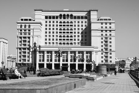 black and white photography. View of the modern building of the hotel complex. Hotel for four seasons. people in the park.のeditorial素材