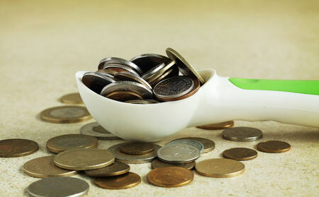 Spoon full of moneyの写真素材