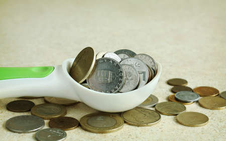 Spoon full of moneyの写真素材