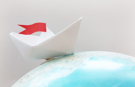 Travel concept with paper boat
