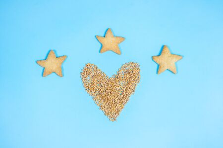 Wheat grain in the form of heart on a blue background