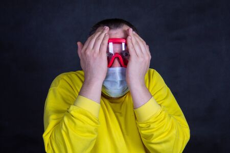 A person wearing a yellow shirt is holding a cellphoneの写真素材