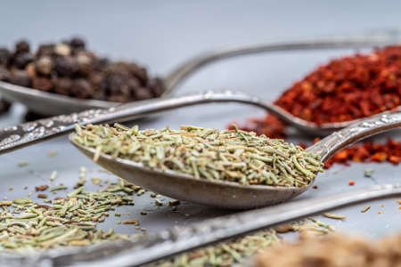 Variety of herbs and spices on slate background.の写真素材