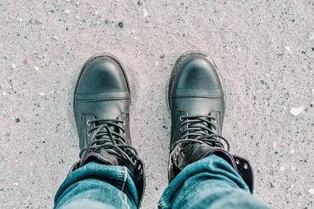 Beach sand walking in black shoesの写真素材