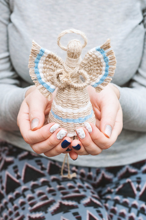 Textile angel doll in the girls handsの写真素材