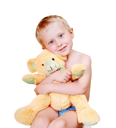 Open smiling little boy portrait with his teddy bear love toy on white backgroundの写真素材
