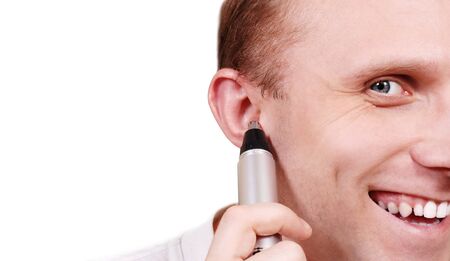 Close up man portrait with trimmer near his earの写真素材