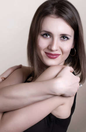 Calm face of young beautiful woman with charming smileの写真素材