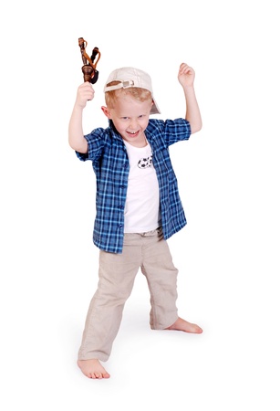 Victirious gesture from little madcap boy with sling shoot on white backgroundの写真素材