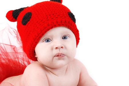 Cute baby in funny ladybug hat portraitの写真素材