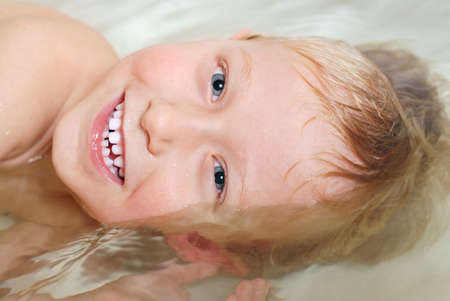 Close up portrait bathing and diving little boyの写真素材