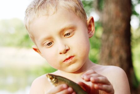 Portrait little boy with catched fish
