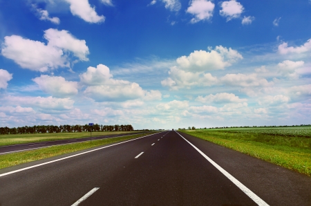 Clear highway under blue cloudy sky in sunny dayの写真素材