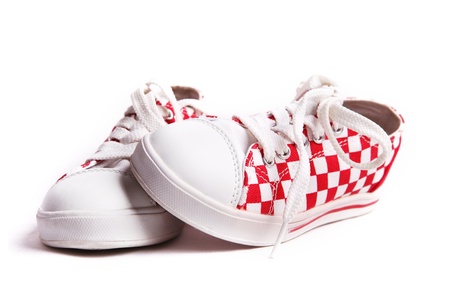 The pair of bright checkered child sneakersの写真素材