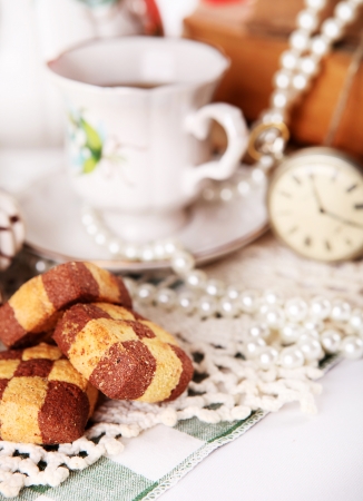Close up porcelain cap with pocket watch and Checkerboard cookies の写真素材