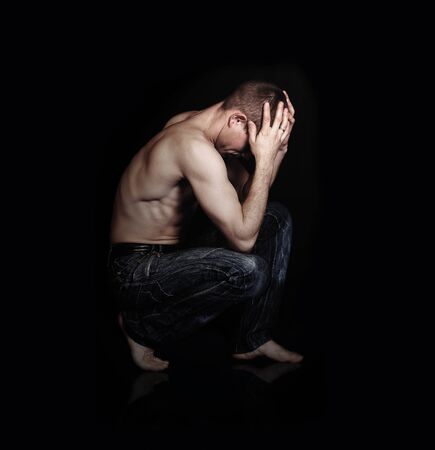 Image sitting in frustration pose young manの写真素材