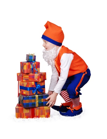 Funny gnome with christmass presents in the snowの写真素材