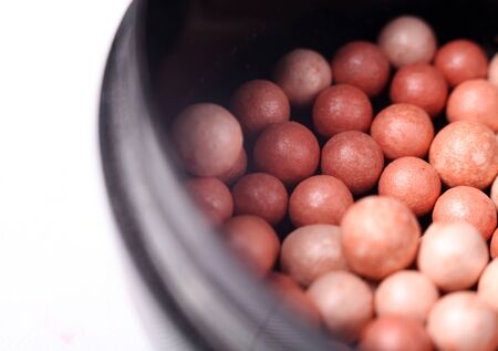 Pink blusher balls into container closeup imageの写真素材