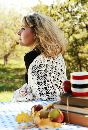 Woman enjoyed with sun light on autumn picnicの写真素材