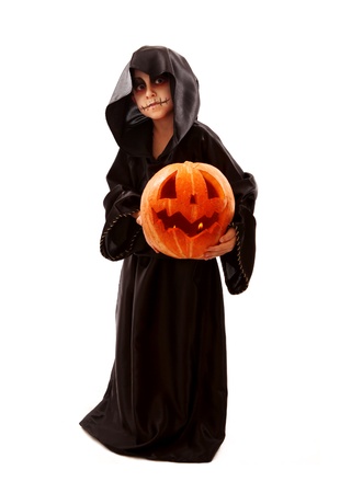 Boy in halloween zombie fancy-dress with pumpkin in hands の写真素材