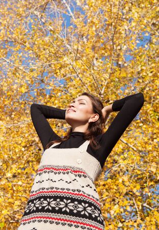 Beautiful young woman enjoyed sunny autumn dayの写真素材
