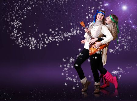 Beauty girls with balalika dancing over purple background with snow flakesの写真素材