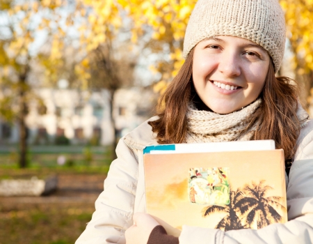 Pretty young student girl in autumn outddoorの写真素材