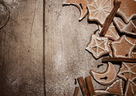 Wooden bacckground with christmas cookies and spices on it
