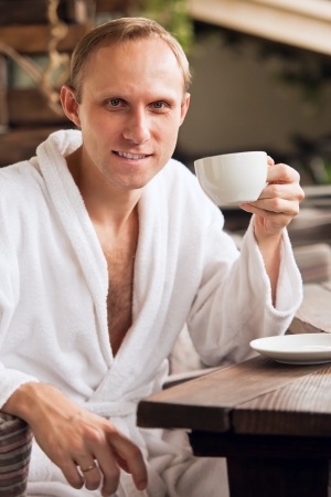Attractive man portrait with cup of morning coffeeの写真素材